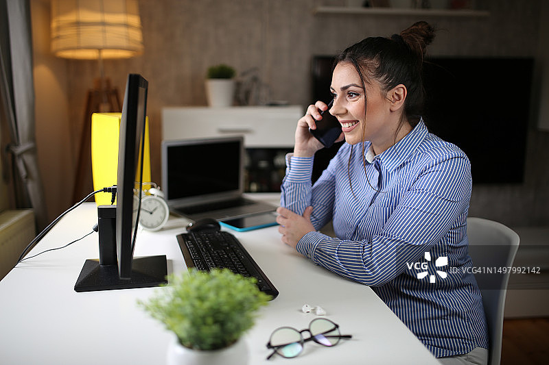 年轻女企业家工作中的多任务处理图片素材