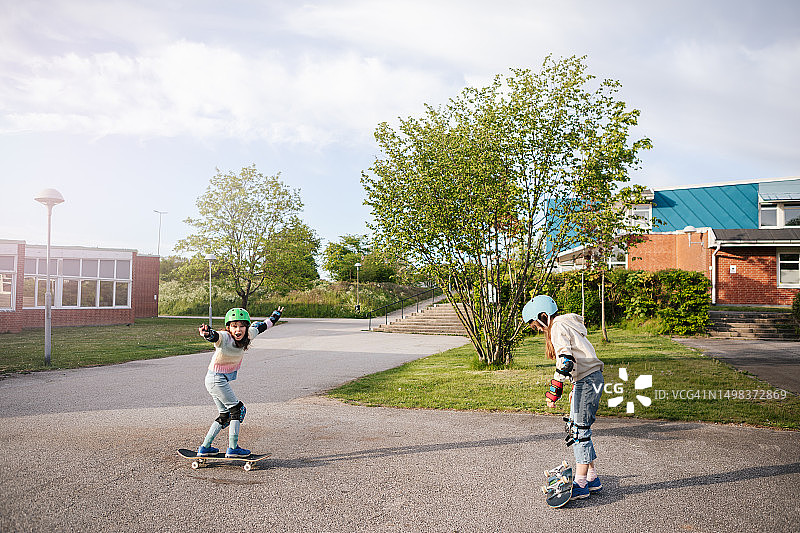 姐妹们玩滑板的快乐时光。图片素材