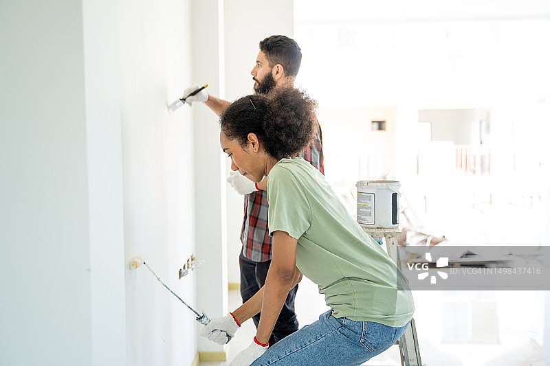 朋友们一起粉刷房子图片素材