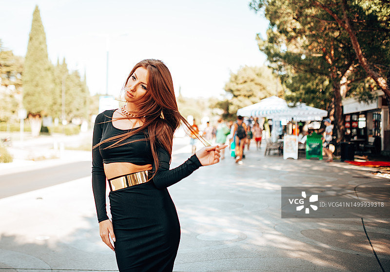 城市里穿黑裙子的时尚女人图片素材