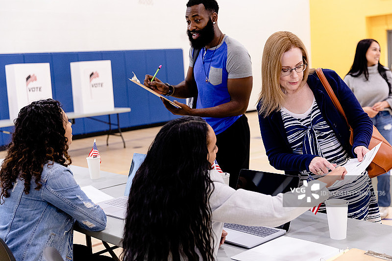 志愿者协助不同人群参与投票选举图片素材