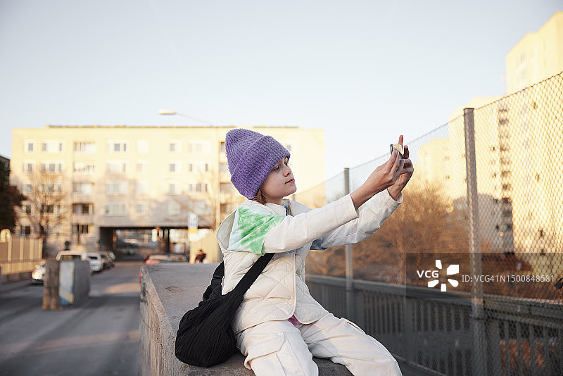 男孩坐着自拍的景象图片素材