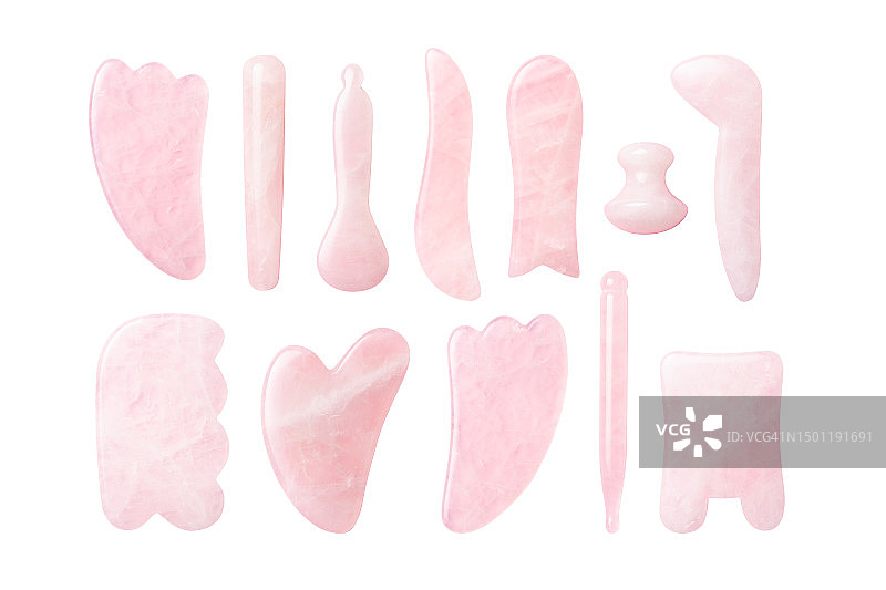 白色背景上孤立的粉色水晶刮痧工具合集图片素材