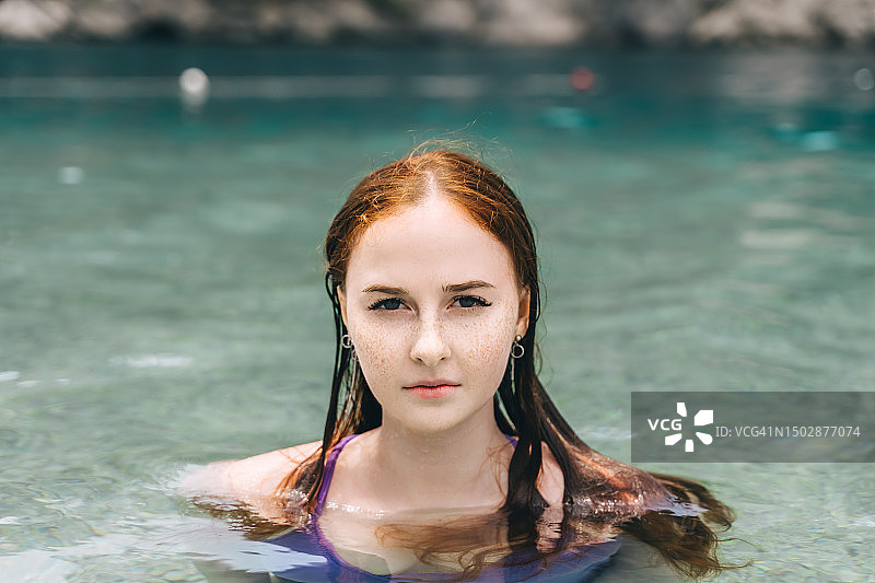 在清澈海水中的年轻红发女子肖像，美丽概念图片素材
