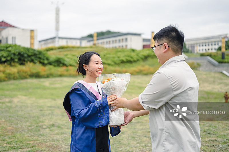 年轻男子祝贺年轻女子硕士毕业图片素材