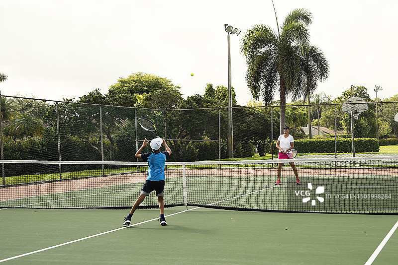 母子穿运动服在户外打网球图片素材