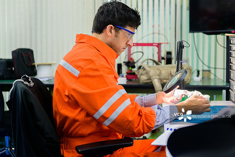 检查和修理机器人零件的专业技术人员图片素材