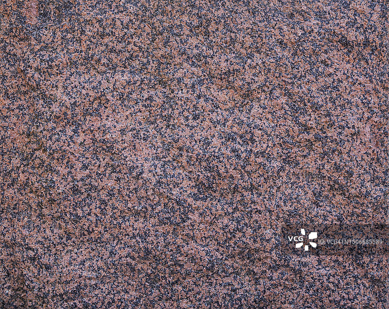 天然红色花岗岩石材表面纹理特写，正面视图图片素材