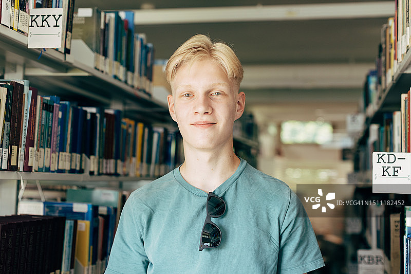 图书馆里的年轻金发男子肖像图片素材