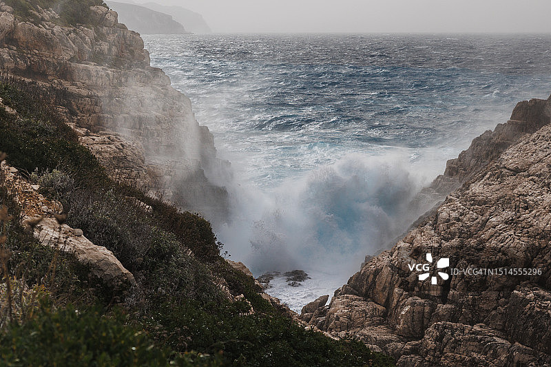 巨浪冲击科拉科尼西岛的岩石海岸图片素材