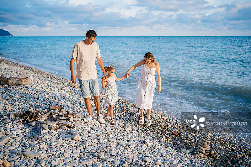 父母带孩子在海边散步图片素材