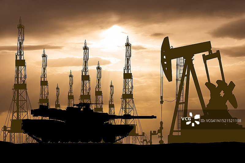 以钻机和泵为背景的油田上的坦克图片素材