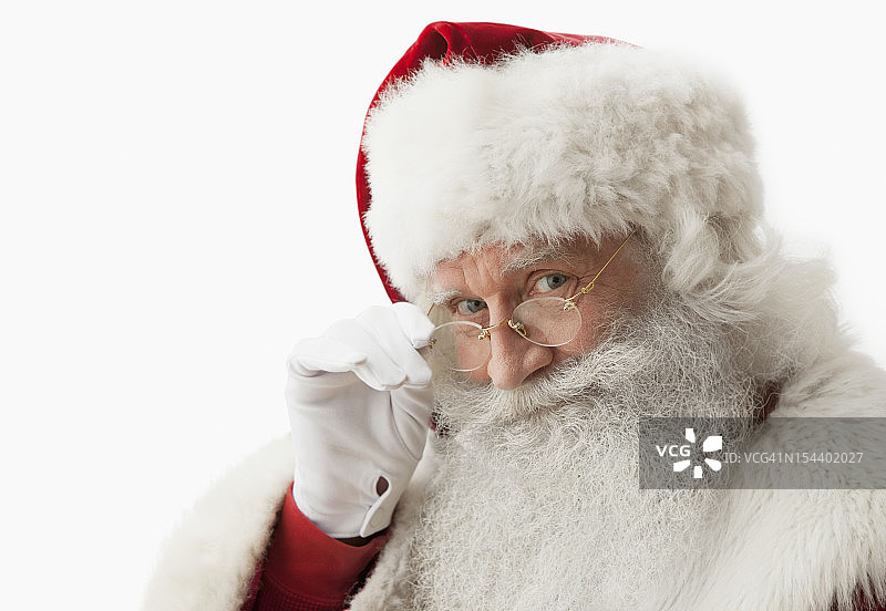 圣诞老人触摸眼镜的特写图片素材