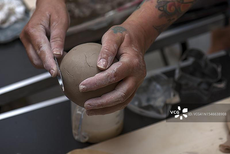 德国巴伐利亚，陶艺师的手正在制作泥球图片素材