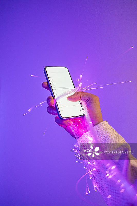 手持智能手机和光纤特写图片素材