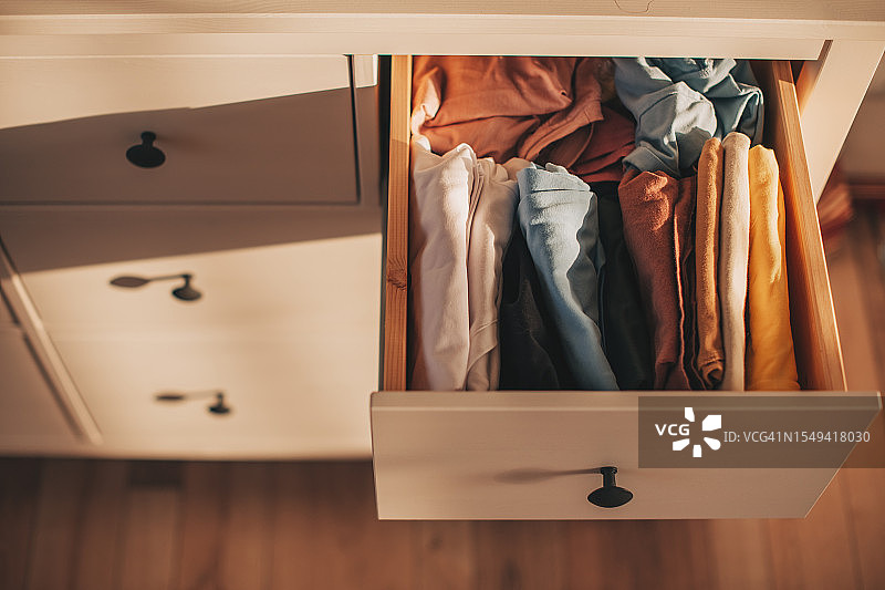 手拿衣物的抽屉柜图片素材