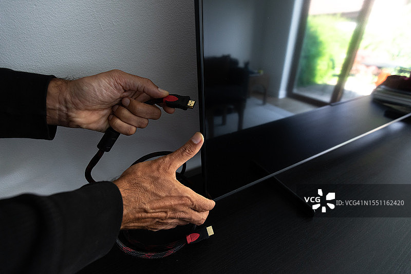 男人拿着一根HDMI线图片素材