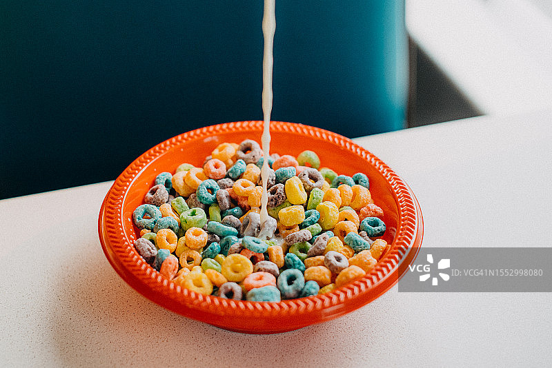 往麦片碗里倒牛奶图片素材