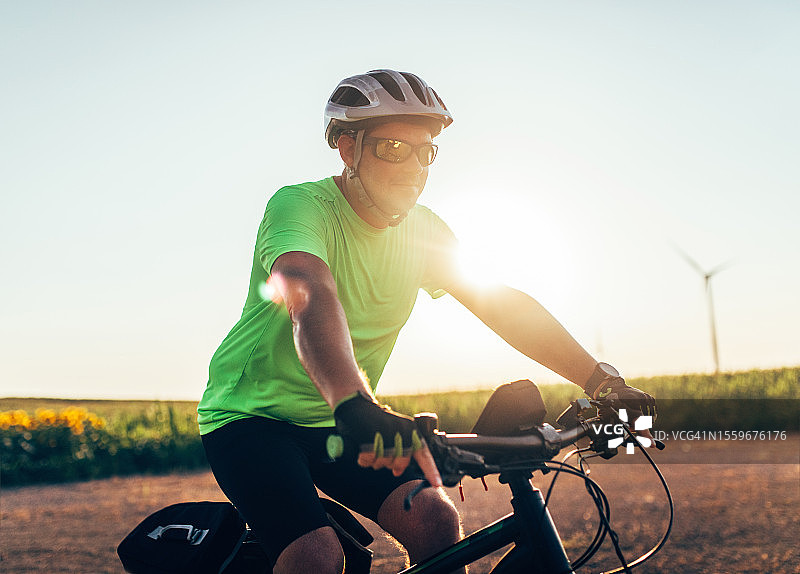 在乡村道路上骑山地自行车的探险者图片素材