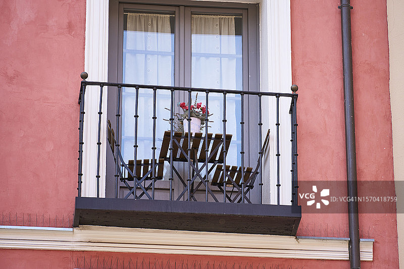 公寓外的金属阳台与木桌椅图片素材