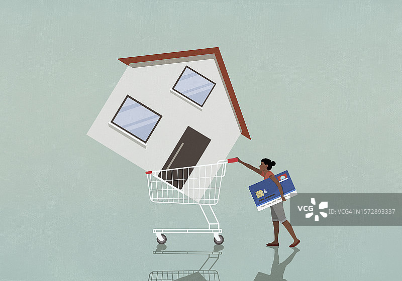 拿着信用卡在购物车里推房子的女人图片素材