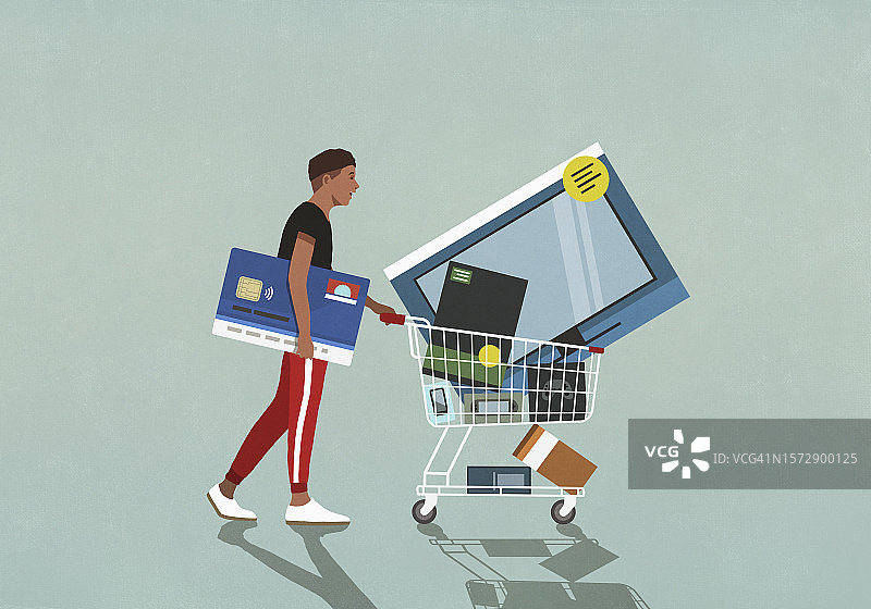 男顾客用信用卡推着装有科技商品的购物车图片素材