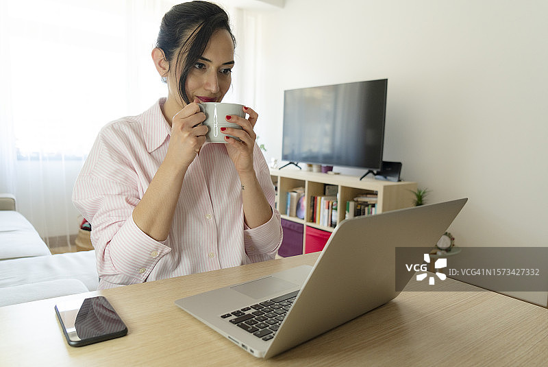 年轻女人在家用笔记本电脑进行视频通话图片素材