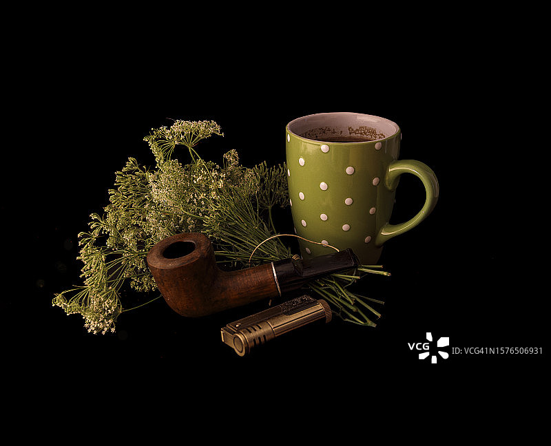 咖啡杯和植物特写，黑色背景图片素材