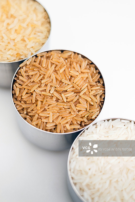 白色背景上拍摄的三种米：糙米、长粒米和茉莉香米图片素材