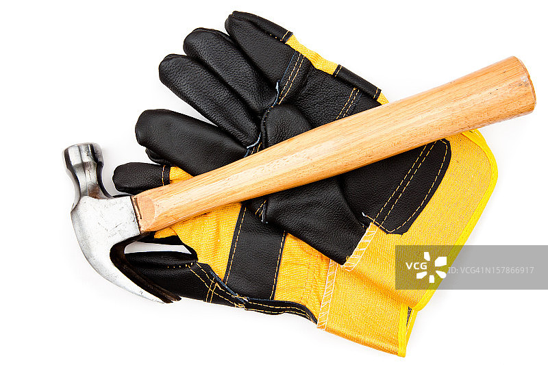 放置在两只皮手套上的锤子图片素材