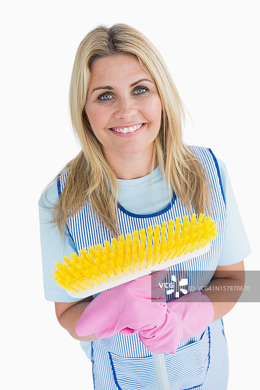 清洁女工拿着黄色扫帚图片素材