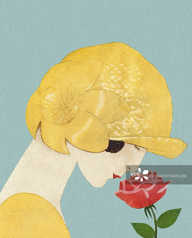 戴帽子闻玫瑰花的女人图片素材