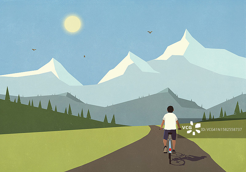 男人在山谷道路上骑自行车图片素材