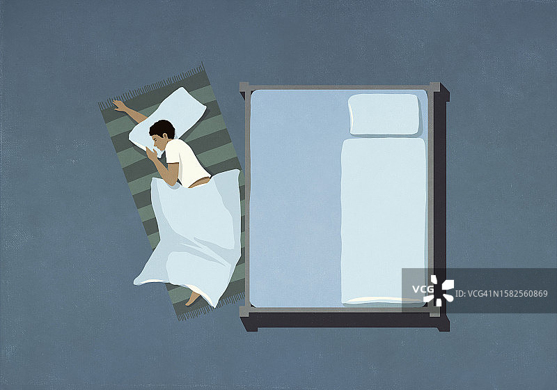 男人睡在地板上床边的鸟瞰图图片素材