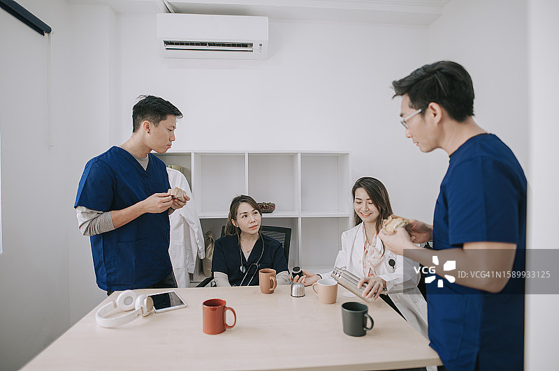 在员工休息室享受茶歇的亚洲医生和护士图片素材