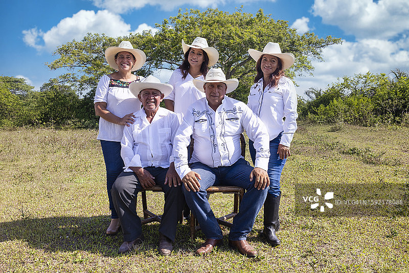 多云天空下的户外牧场家庭照图片素材