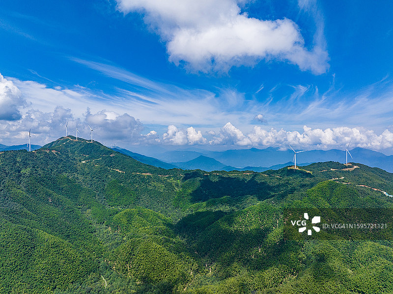 蓝天白云下山间风力发电设备航拍图片素材