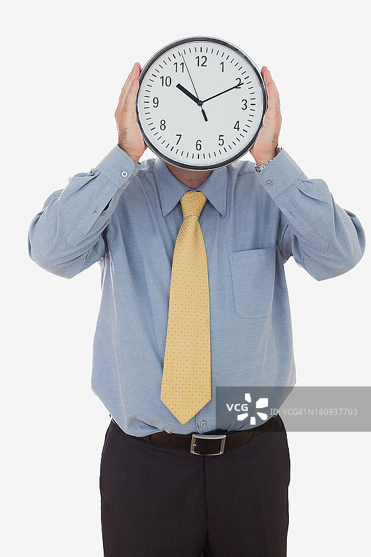 面带时钟的商人图片素材