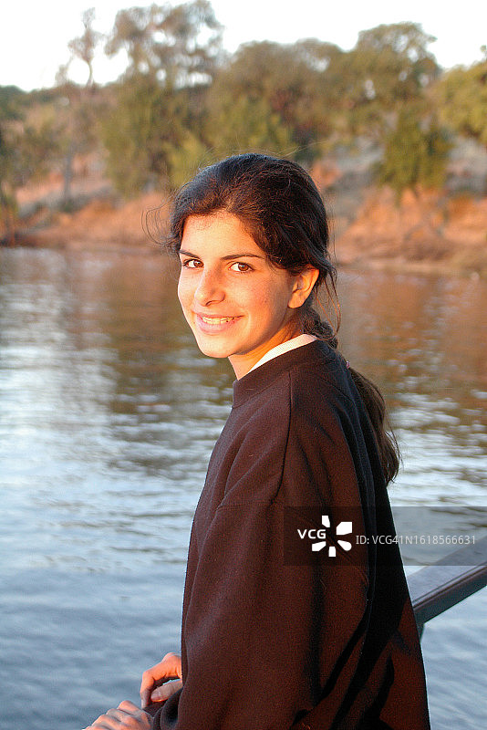 戴着牙套站在博茨瓦纳乔贝河边的少女图片素材