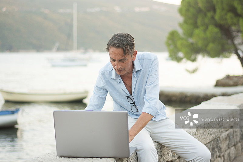 中年男子在海滩上工作图片素材