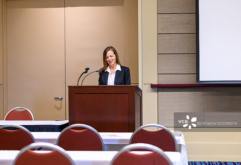 在领奖台上进行演示或练习演示的女商人图片素材
