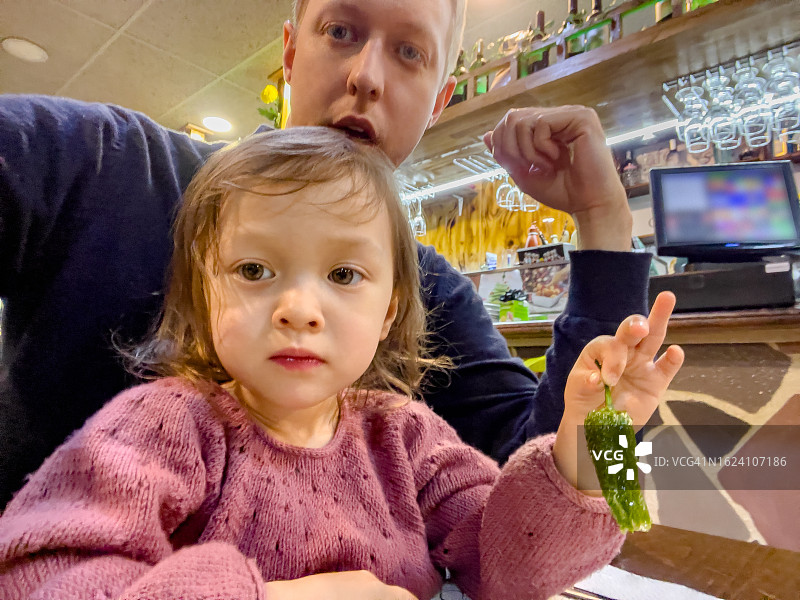 父亲和孩子拿着辣椒自拍图片素材