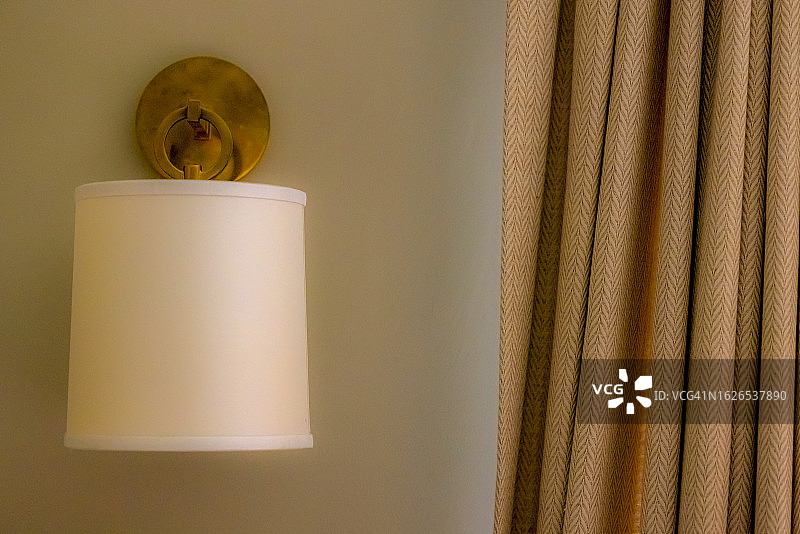 褶皱窗帘旁的桶式壁灯图片素材