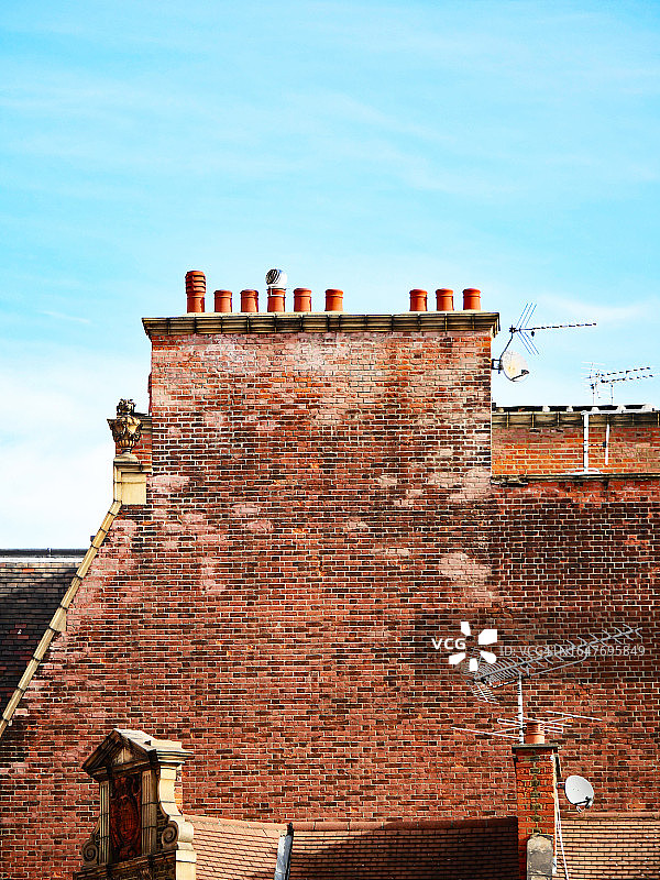英国伦敦的老砖墙，带烟囱和天线图片素材