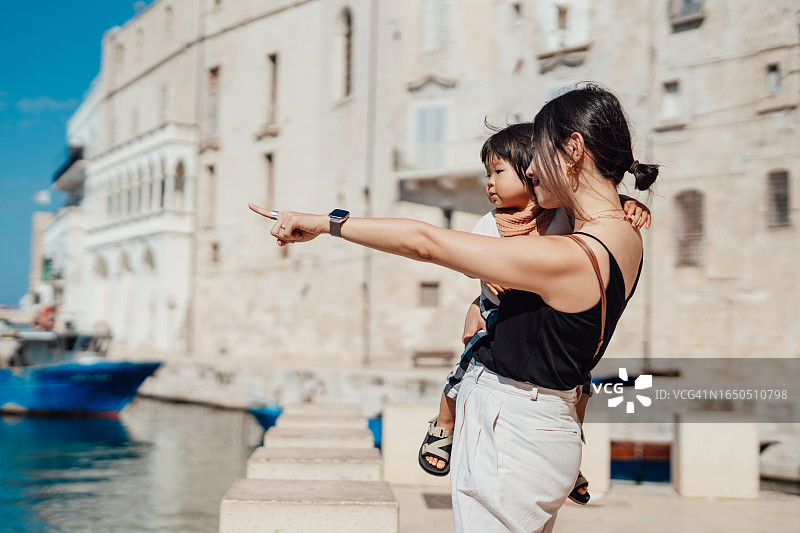 年轻的亚洲母亲和女儿在意大利海滨小镇游玩图片素材