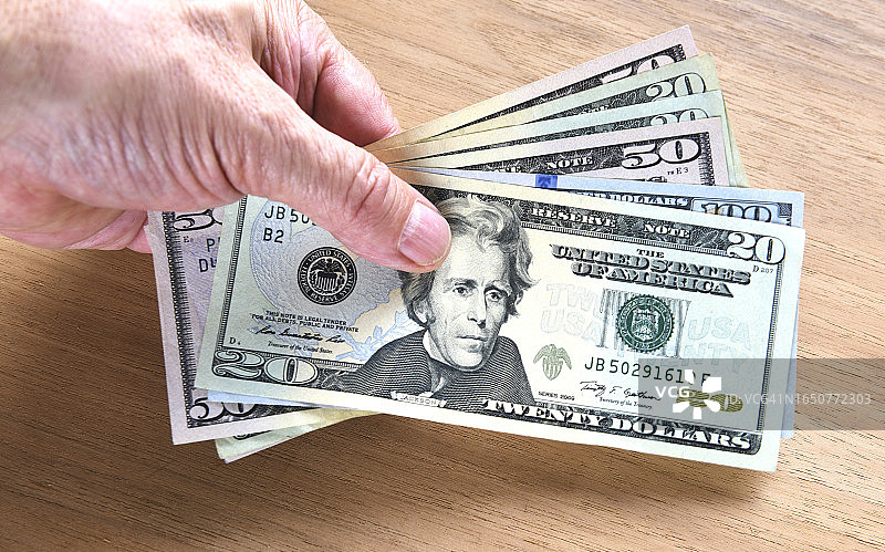手持美元纸币图片素材