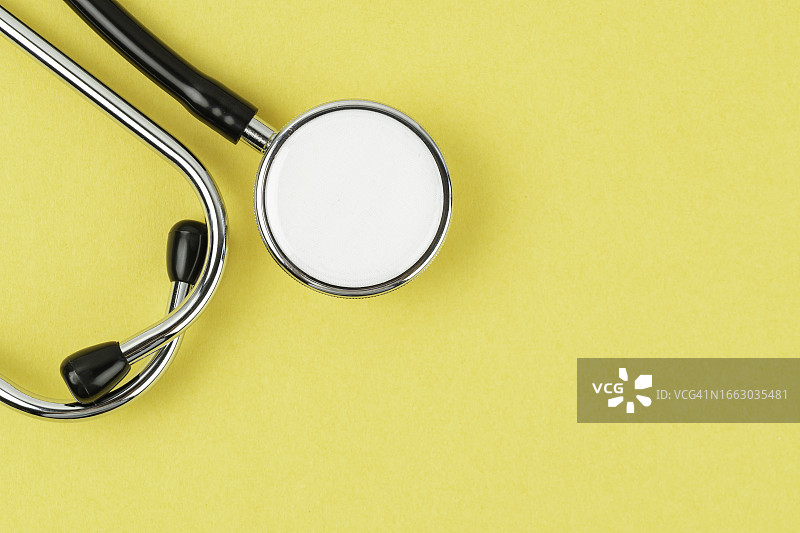 明亮黄色背景下的听诊器图片素材