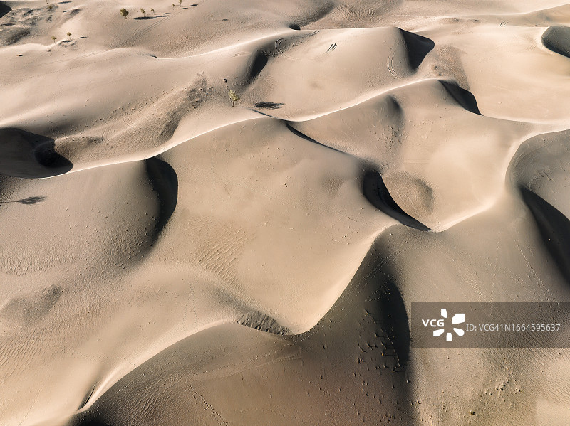 巴基斯坦北部斯卡杜卡特帕纳冷沙漠沙丘日落航拍无人机景观：雪帽山环绕，喀喇昆仑山脉图片素材