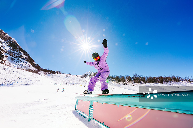 女人在阳光明媚的极限滑雪公园玩单板图片素材
