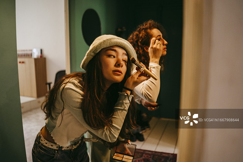 年轻女子和朋友们在家中化妆图片素材